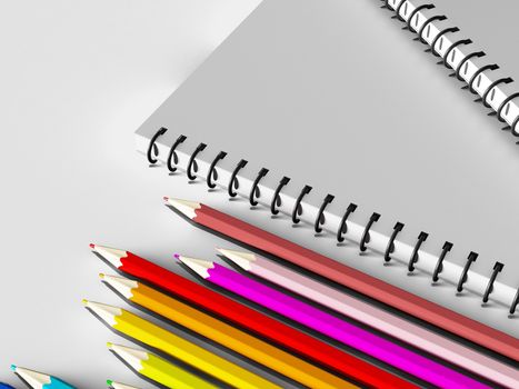 notebook with colored pencils on White background, stationary object