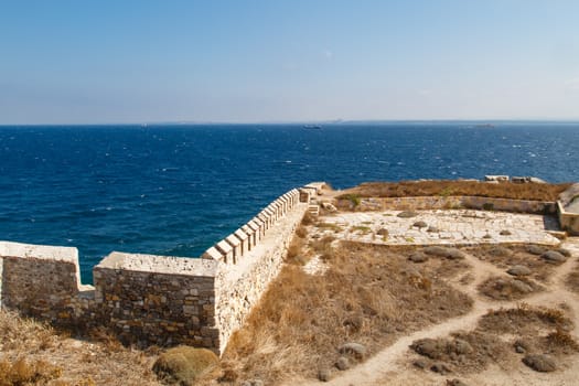 Medieval castle in Tenedos, Bozcaada, Turkey at seacoastline.