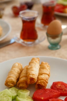 Rich and delicious pie with tea in Turkish breakfast.