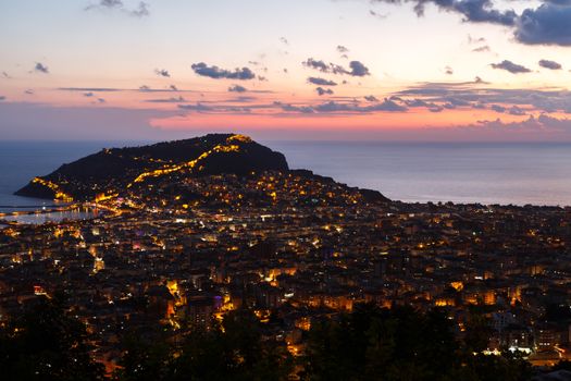 Night view of peninsula in Antalya, Alanya Castle with lighting in blue hours.