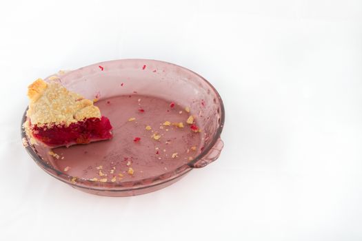 Pie sitting in it's glass pan waiting for someoen to eat it