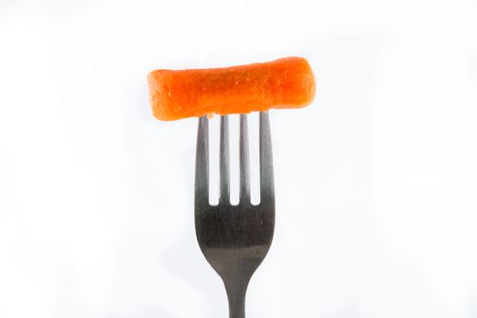 One carrot on a fork isoalted against a white background