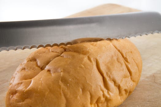 nice sharp bread knife slicing a loaf of fresh bread