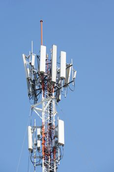 Antenna cellular mobile phone tower for telecommunication in blue sky.