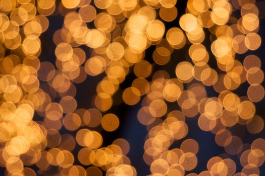 Defocused of glitter or golden bokeh circle at night as background.