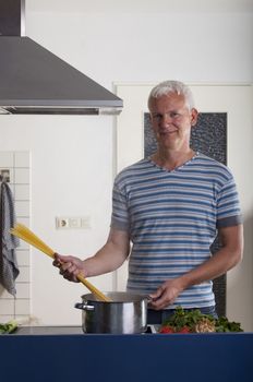 man cooking pasta in a kitchen