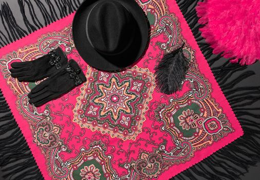 Fashion clothes stylish set, colored shawl, accessories. Ethnic traditional pattern pink cashmere wool headscarf, trendy black hat, gloves, feather.Unusual creative elegant.Autumn winter.Vintage retro