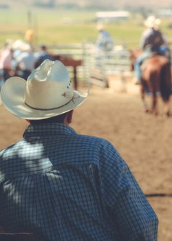 Rear view of man wearing cowboy hat.