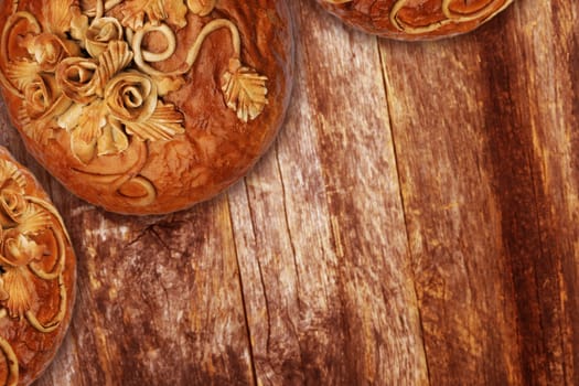 Bread Decoration Baking Art. Regional Decorative Rye Bread on a Aged Wood Table.