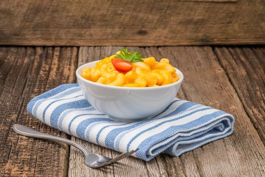 Bowl of homemade macaroni and cheese with garnish.