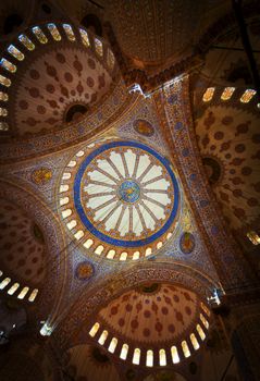 ISTANBUL, TURKEY - APRIL 26, 2012: The tiled and inscribed ceiling below the main dome at the Blue Mosque, on April 26 in Istanbul, Turkey.
