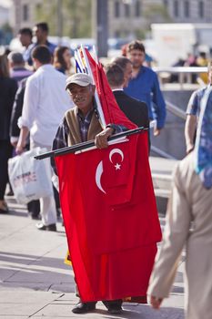 ISTANBUL, TURKEY – APRIL 25: Unidenified street vendor selling Turkish flags prior to Anzac Day on April 25, 2012 in Istanbul, Turkey. 