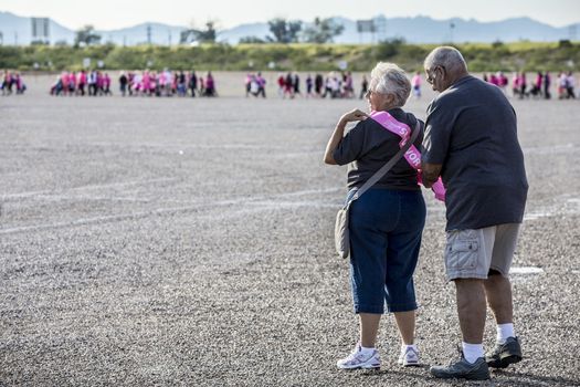 TUCSON, PIMA COUNTY, ARIZONA, USA - OCTOBER 18:  Unidentified man helps unidentified women put on survivor sash at the 2015 American Cancer Society Making Strides Against Breast Cancer walk, on October 18, 2015 in Tucson, Arizona, USA.