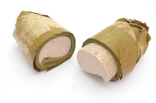 Vietnamese steamed pork sausage wrapped under banana leaf, two half roll