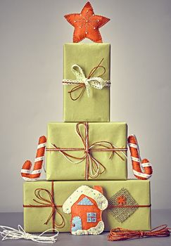 Gift boxes like fir tree. Christmas, candy cane house and star. Kraft paper bows ribbons lace. Festive creative New Year. Retro, vintage, greeting card, party decoration handmade, closeup