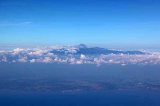 Soft clouds over view from airplane flying