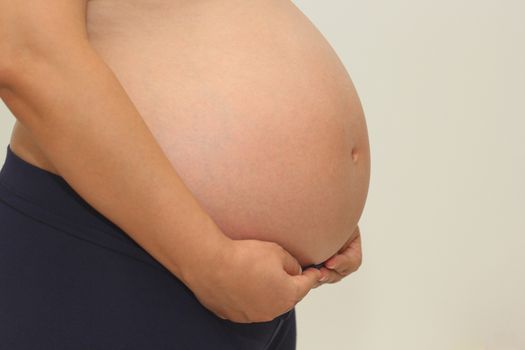 Photo of a cute pregnant woman belly