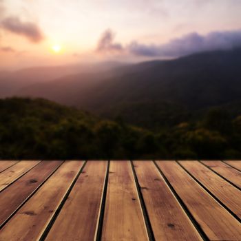 Sunset with mountain and wood floor for background