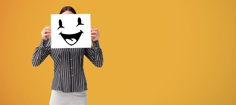 Businesswoman showing a white card in front of her face against yellow