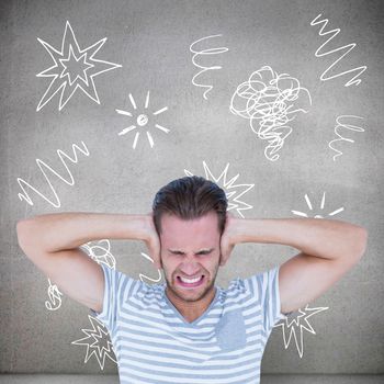 Handsome casual man screaming with hand on ears  against grey room