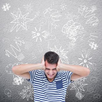 Frustrated man covering ears against grey wall