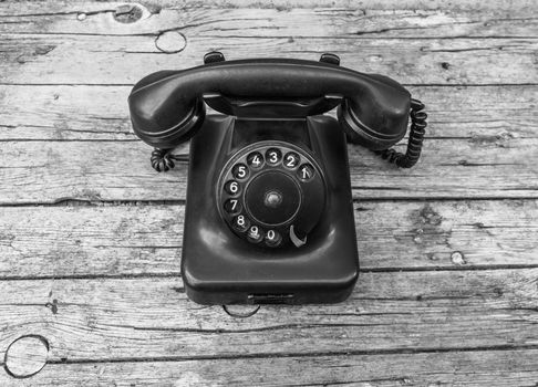 Old telephone on wooden background 