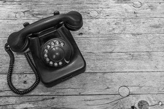 Old telephone on wooden background 