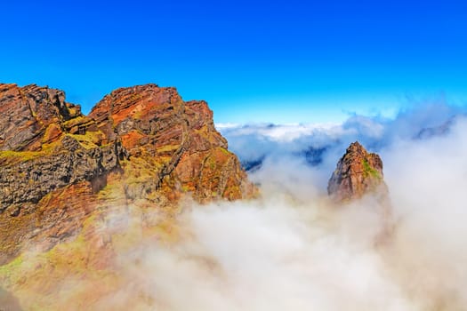Colorful volcanic mountain landscape with clouds - hiking path from Pico do Arieiro to Pico Ruivo, Madeira, Portugal