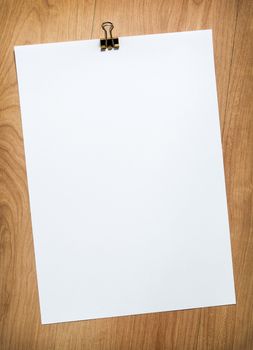 brown wooden boards and blank paper with clip