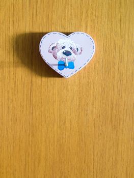 heart shaped hanger with dog image on wooden wall