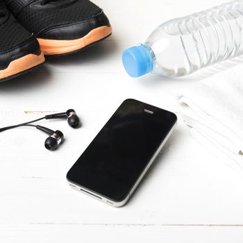 fitness equipment:running shoes,water bottle,towel,smart phone