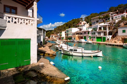 White villas and boats on green water in picturesque fishermen village Cala Figuera, Mediterranean Sea, Mallorca, Spain