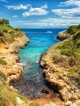 Tiny beach in rocky lagoon on Mediterranean Sea, Cala Manacor, Porto Cristo, Mallorca island, Spain