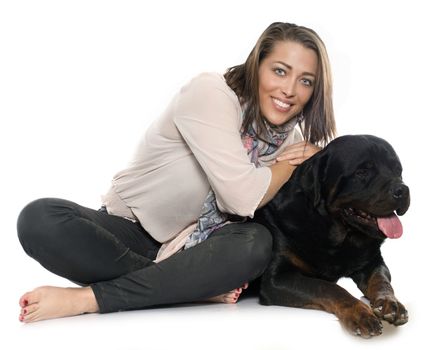woman and rottweiler in front of white background
