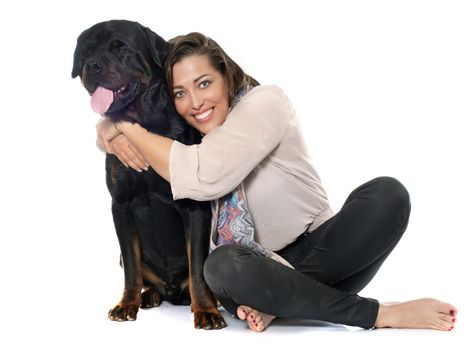 woman and rottweiler in front of white background