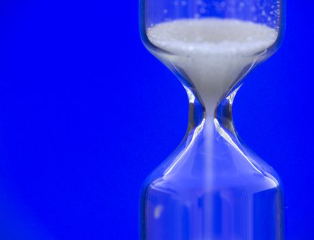 Hourglass against a blue background