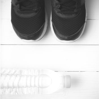 running shoes and drinking water on white table black and white tone color style