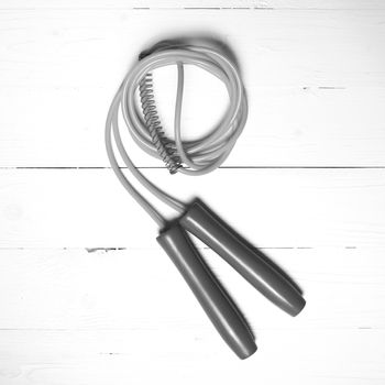 jumping rope on white wood table black and white color style