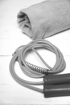 fitness equipment:towel,jumping rope on white wood table black and white color style