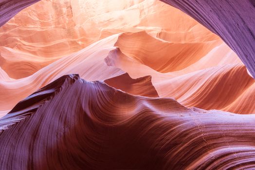 Magnificent nature sun filters into Lower Antelope Canyon Page Arizona USA while the shapes and swirls create and abstract nature image and silica in sandstone reflects some intense colors.Lower Antelope Canyon Page Arizona USA