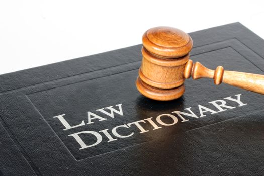 Law dictionary and gavel on white background