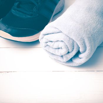 running shoes and towel on white wood table vintage style