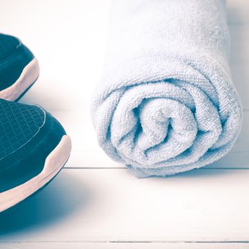 running shoes and towel on white wood table vintage style