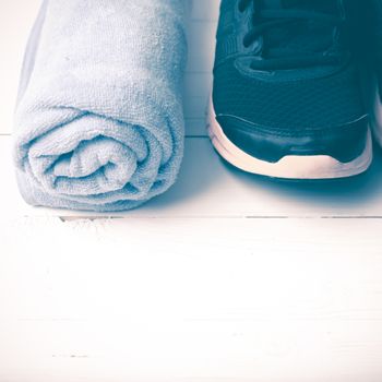 running shoes and towel on white wood table vintage style