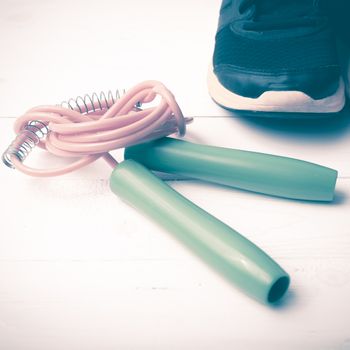 running shoes and jumping rope on white table vintage style