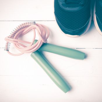 running shoes and jumping rope on white table vintage style