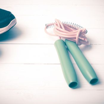 running shoes and jumping rope on white table vintage style