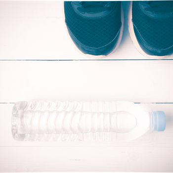 running shoes and drinking water on white table vintage style