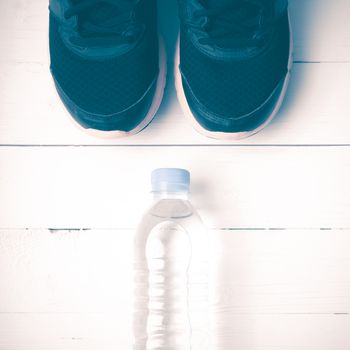 running shoes and drinking water on white table vintage style