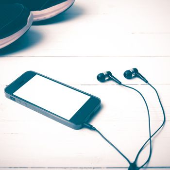 running shoes and phone on white wood table vintage style